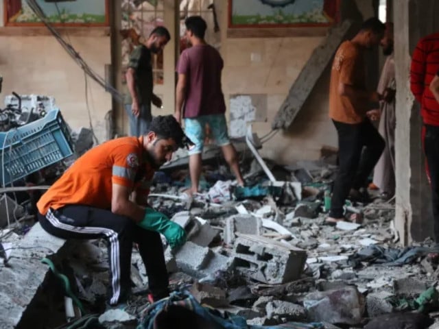 people check the damage inside a school used as a temporary shelter for displaced palestinians in gaza city following an israeli attack photo afp